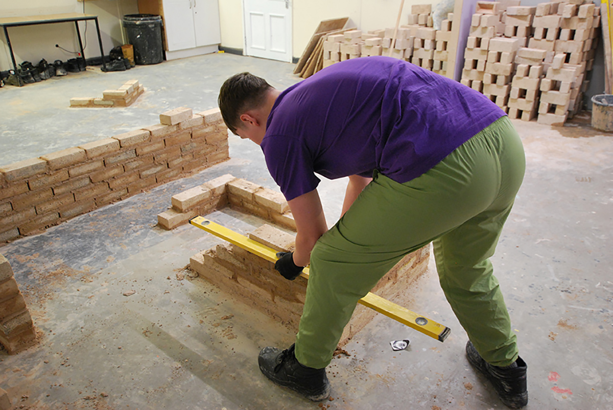 Learner practising bricklaying