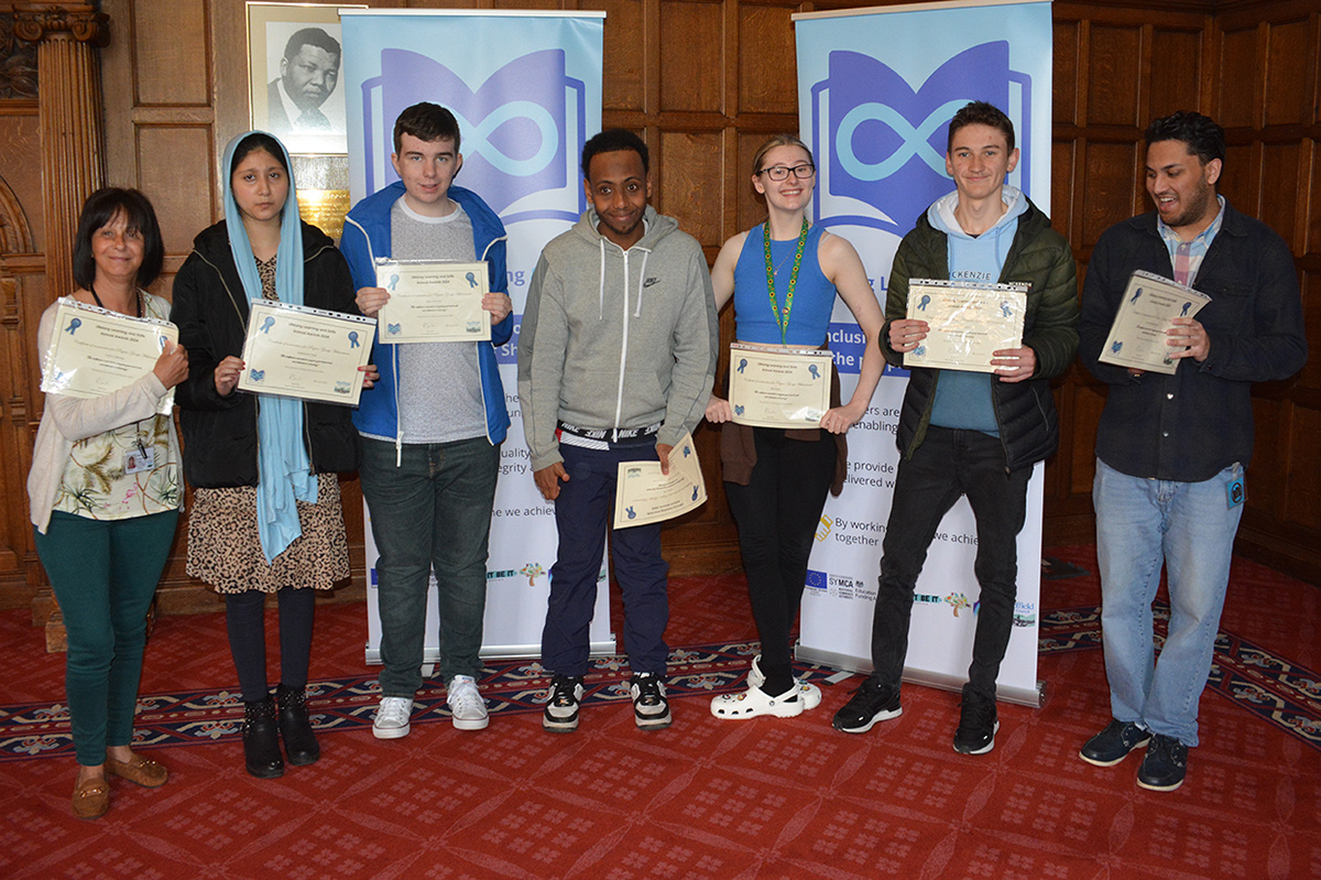 Group of learners lined up with certificates