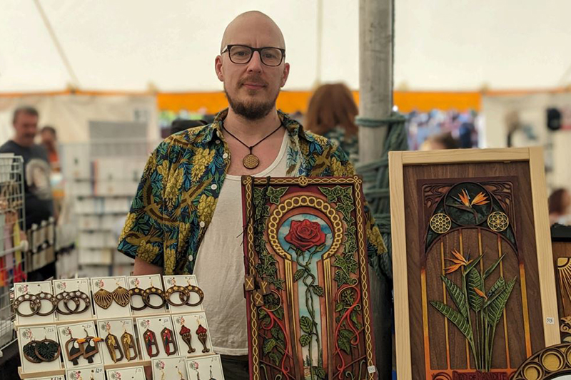 Vendor stood behind handmade crafts