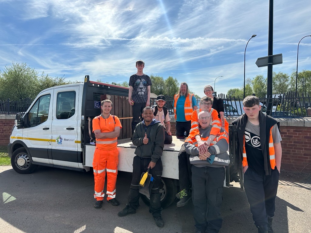 Group of workers sat around a van