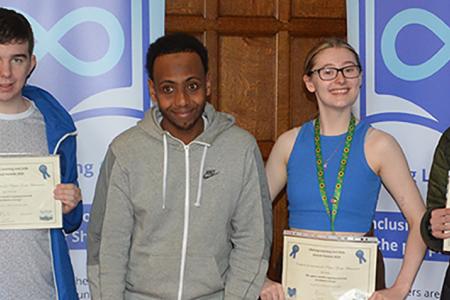 Group of learners lined up with certificates